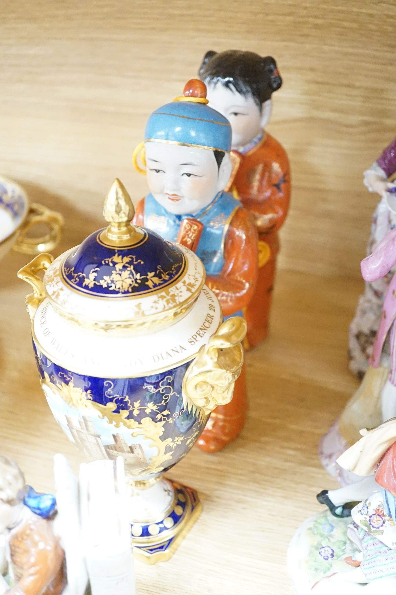 A collection of German and French porcelain figurines, Coalport commemorative urn etc.